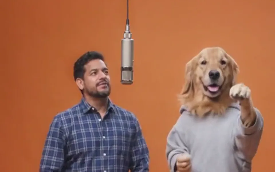 Frame from our demo: a man and his golden retriever in the orange booth.