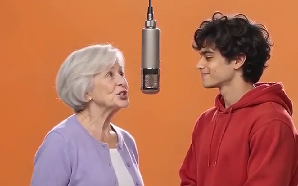 Frame from our demo: a grandmother and her grandson perform together.