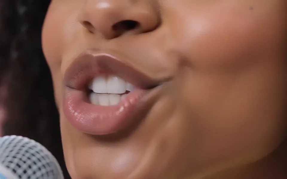 Frame from our APT. demo: the extreme close-up of a singing mouth.