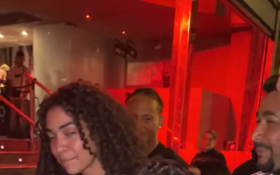 Frame from our Bulin 47 AI demo: the red-lit entrance and stairs behind her, with the crowd around.
