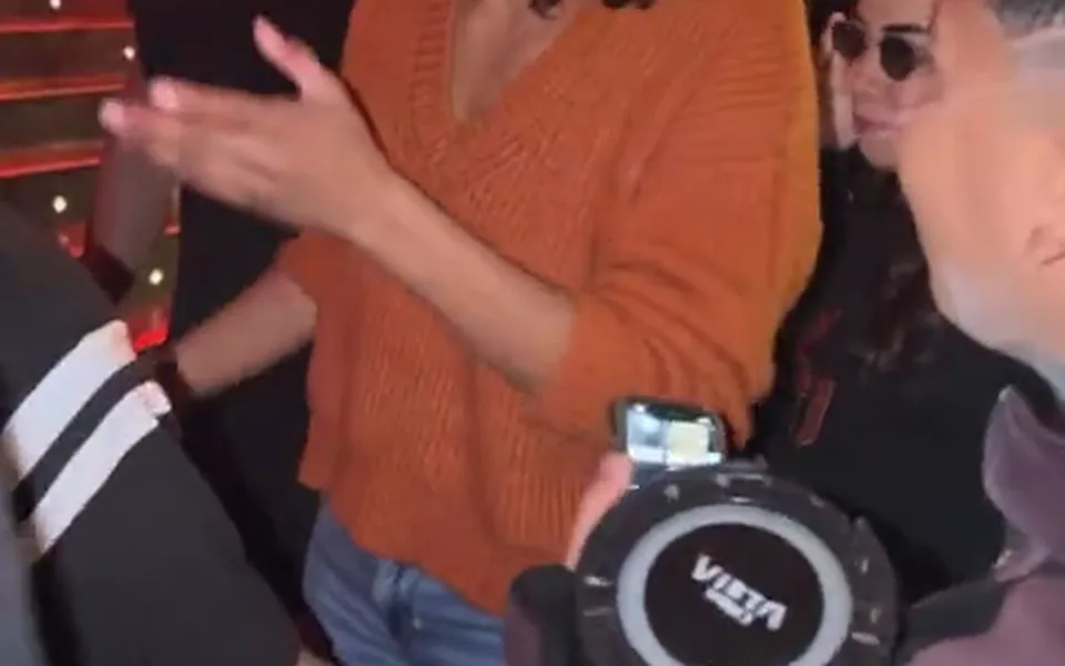 Frame from our Bulin 47 AI demo: the portable speaker and the phone held up in front of her.