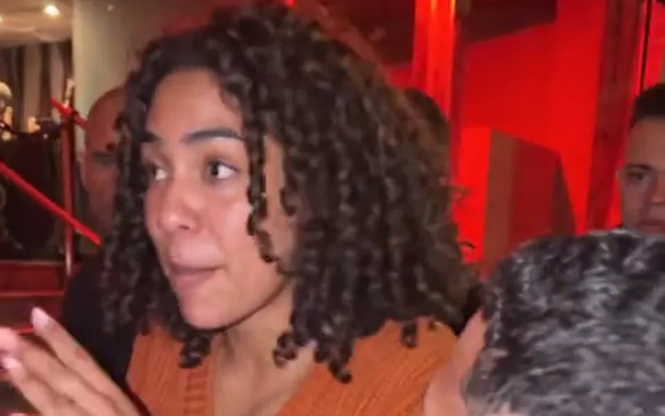 Frame from our Bulin 47 AI demo: her own face, hair and orange sweater from the photo.